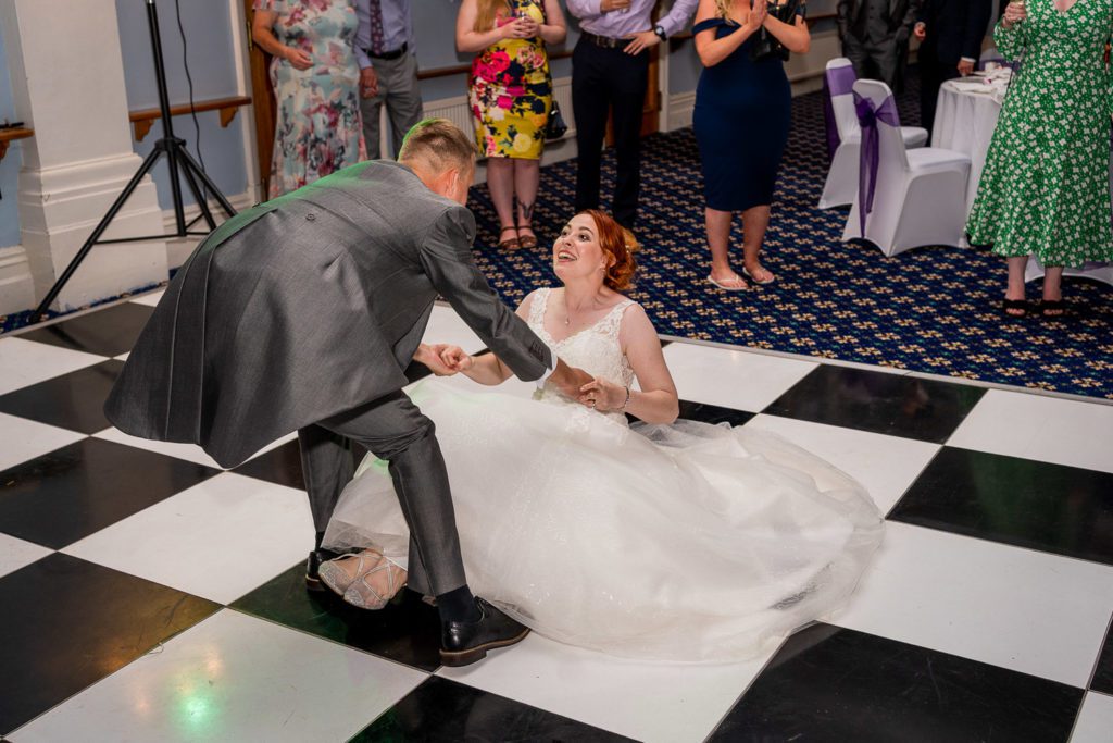 Bride slips while dancing at RAF Henlow and her Groom helps pick her up