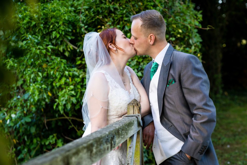 Bride and Groom kissing in the grounds of RAF Henlow