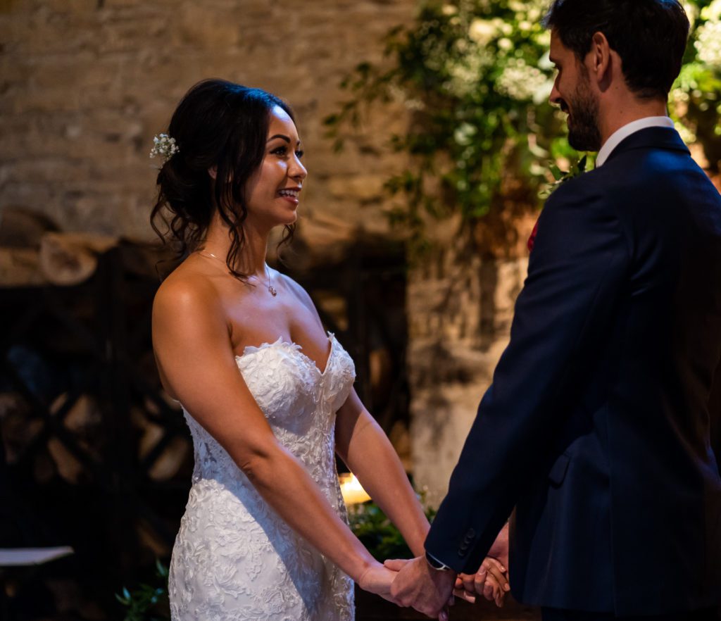 Cripps Barn Wedding venue a couple exchange vows inside