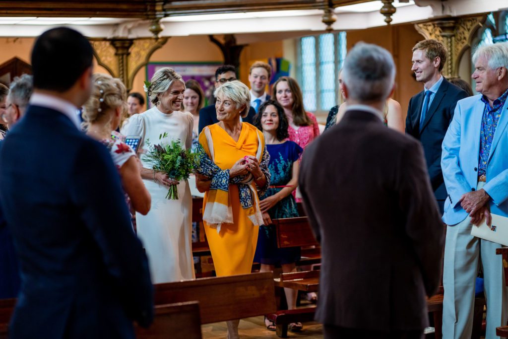 Suzie walking up the Aisle arm in arm with her Mum