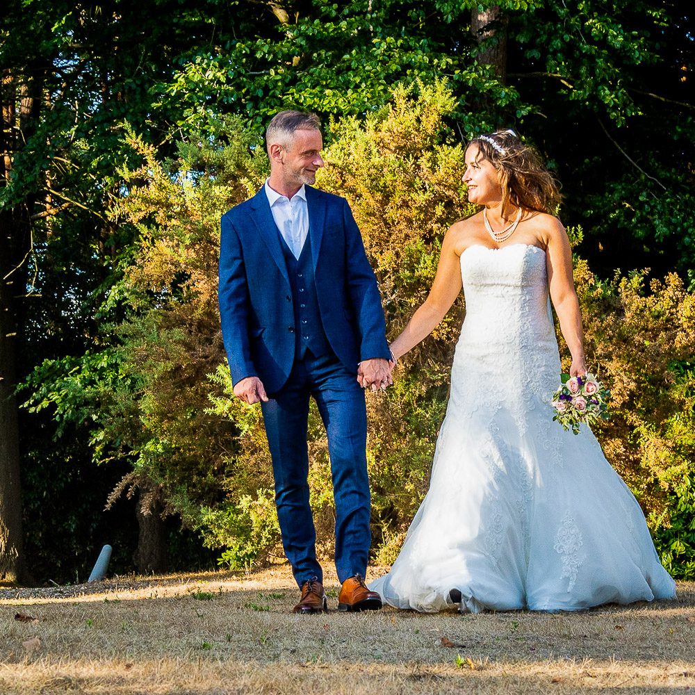 Wedding at Hilton Hotel Cobham where the bride and groom walk along the driveway