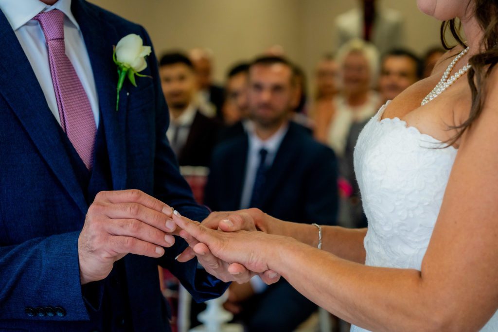 Wedding at Hilton Hotel Cobham exchanging the rings