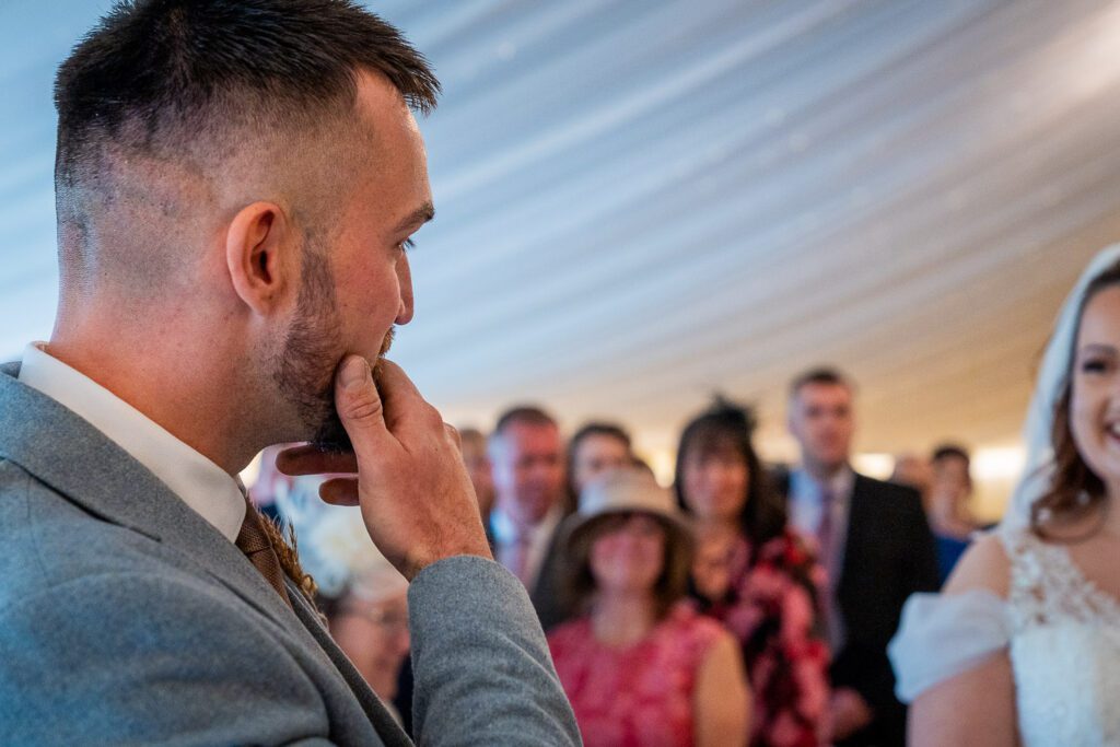 Groom seeing his bride for the first time at the Fennes Essex. Taken by Tim Payne Photography