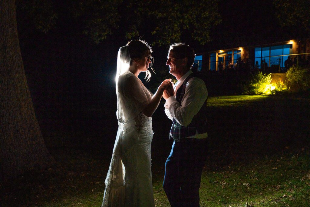 Night time flash lit image of Bride and Groom in the grounds of Brickendon Grange.