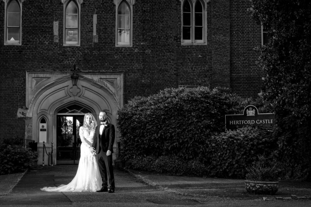 Black and white image of a Bride and groom in the grounds of Hertford Castle.