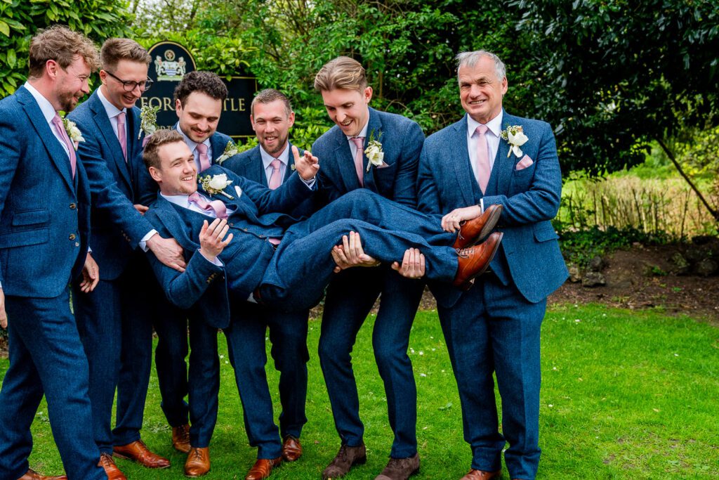 Groom with his groomsmen at Hertford Castle. Taken by Tim Payne Photography a Hertfordshire wedding photographer.