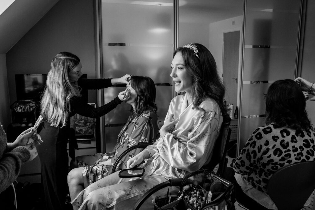 Bride and her bridesmaids getting ready. Taken by Tim Payne Photography a Hertfordshire wedding photographer.