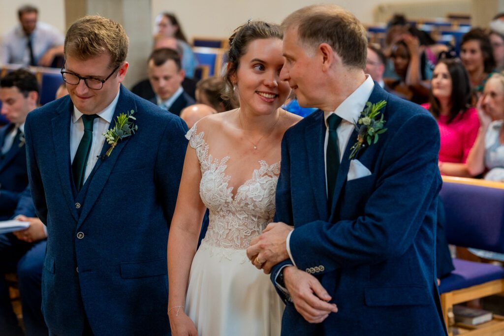 Bride at the alter shares a private moment with her father before she becomes married. Hertford wedding photographer