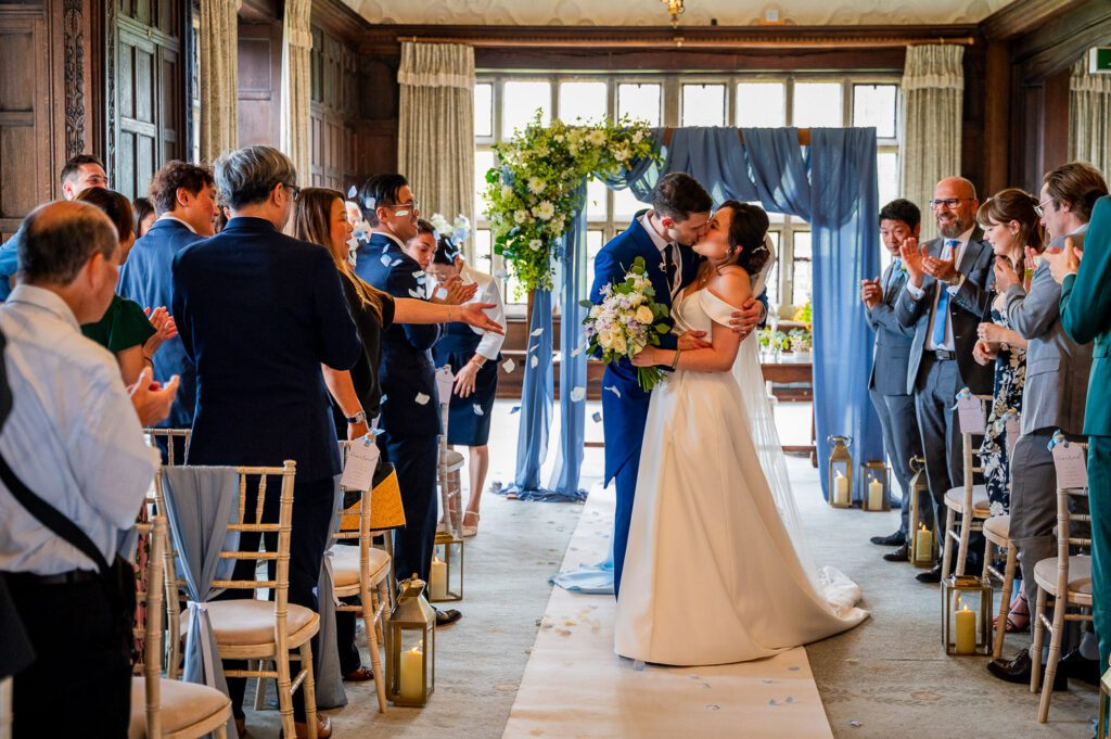 Their first kiss at Fanhams hall Ware. Tim Payne Photography a Hertfordshire wedding photographer