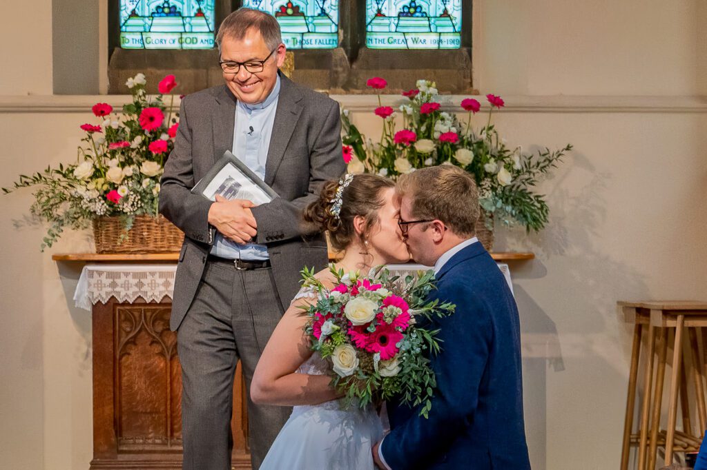 Bride and Groom having their first Kiss, having just completed their wedding ceremony. Tim Payne Photography, a Hertford Wedding photographer