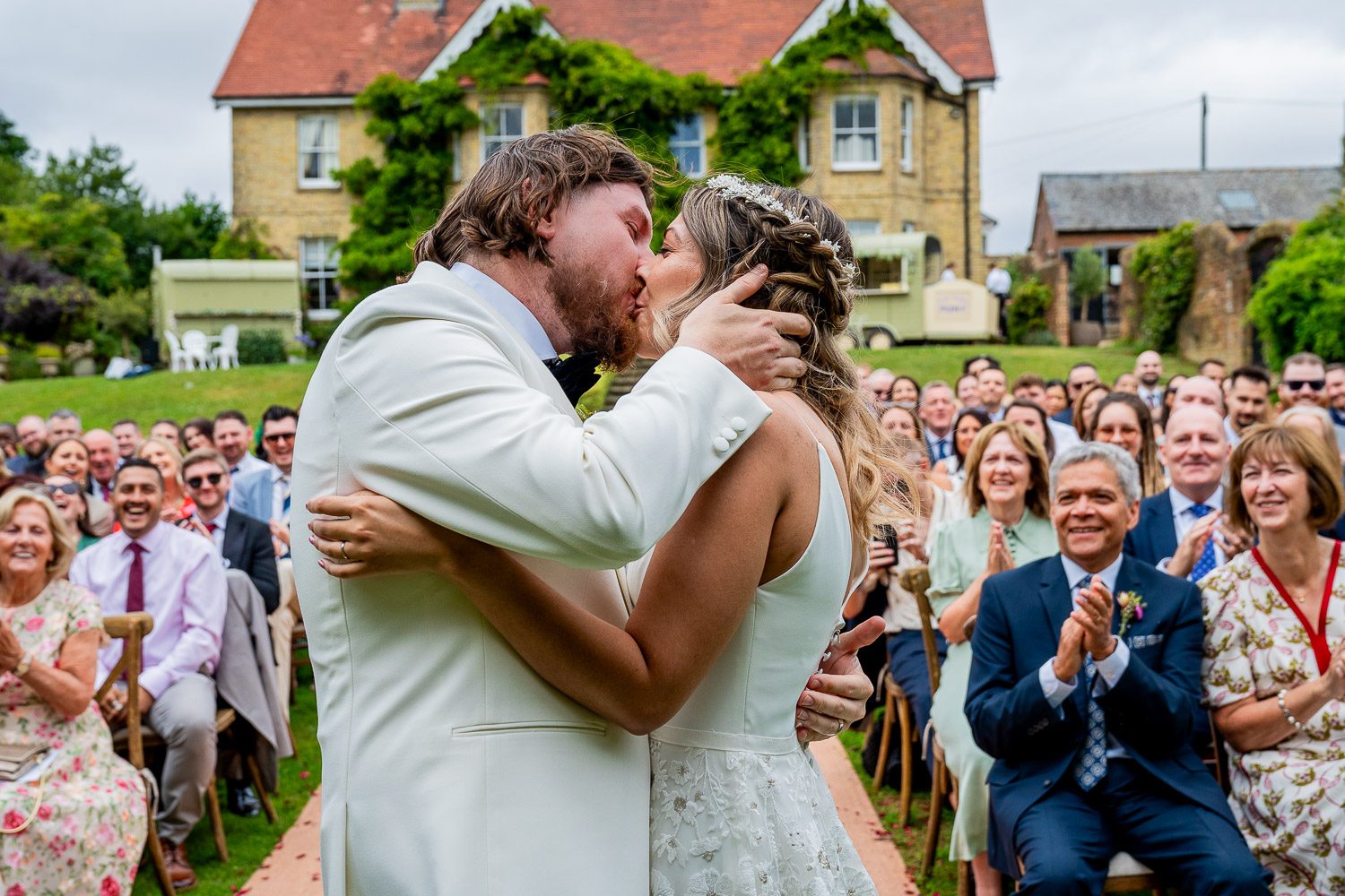 Wedding Photography Packages - A bride with her hair done is sitting in a dressing gown having her make-up applied