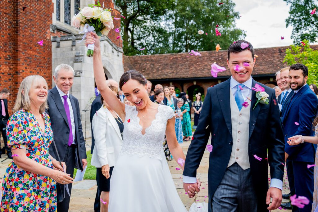 Bride and Groom and their confetti at the Grove Hotel, Watford. Tim Payne Photography, a Hertfordshire wedding photographer.