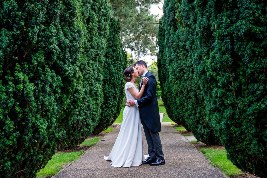 Bride and Groom kissing at the Grove Hotel, Watford. Tim Payne Photography, a Hertfordshire wedding photographer.