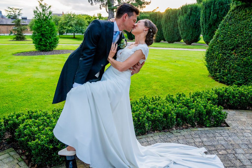 Bride and Groom kissing at the Grove Hotel, Watford. Tim Payne Photography, a Hertfordshire wedding photographer.