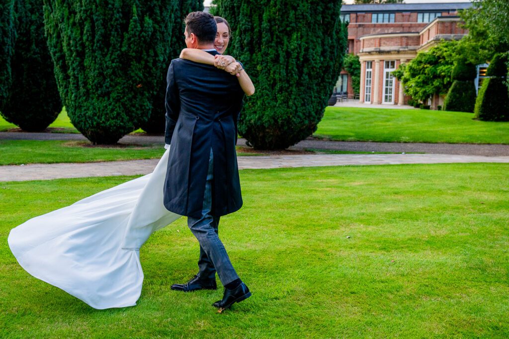 Bride and Groom dancing in the grounds of the Grove Hotel, Watford. Tim Payne Photography, a Hertfordshire wedding photographer.