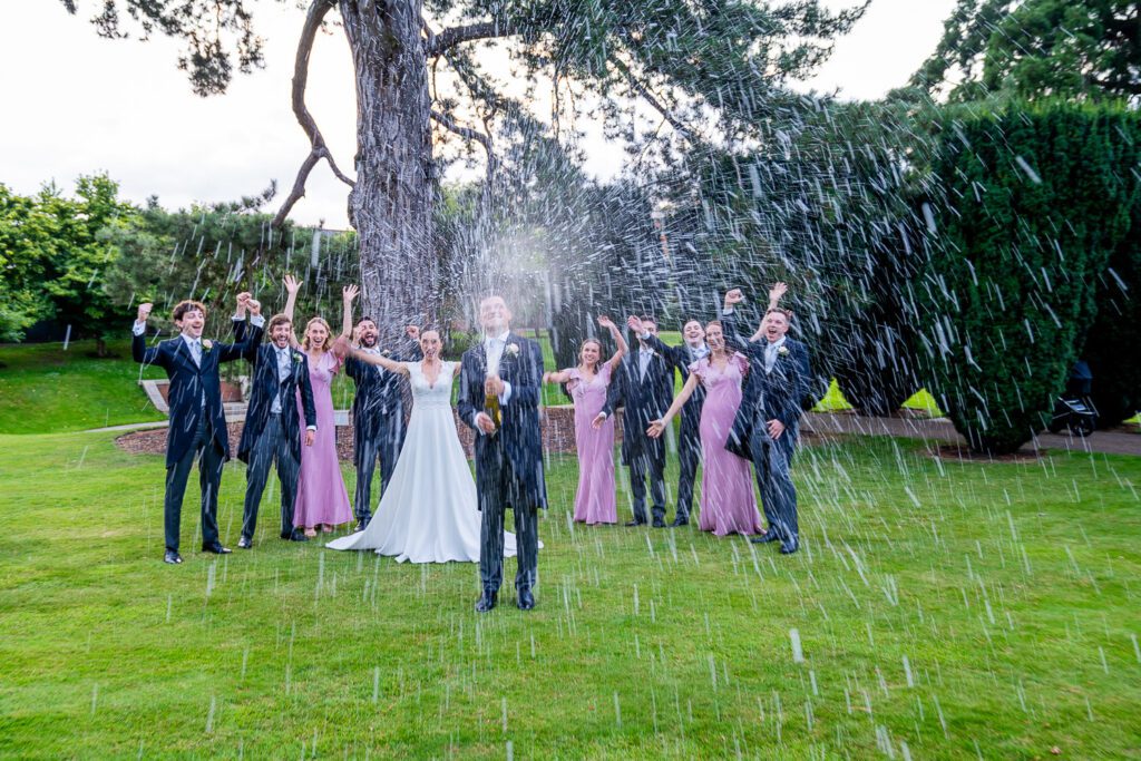 Champagne spray at the Grove Hotel, Watford. Tim Payne Photography, a Hertfordshire wedding photographer.