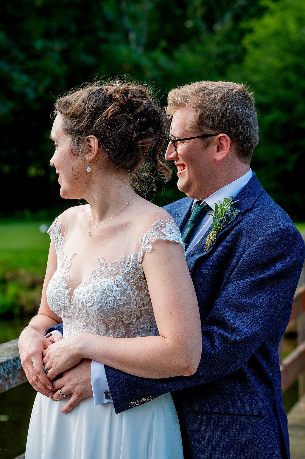 The bride stood in front of the groom, both looking off to their right
