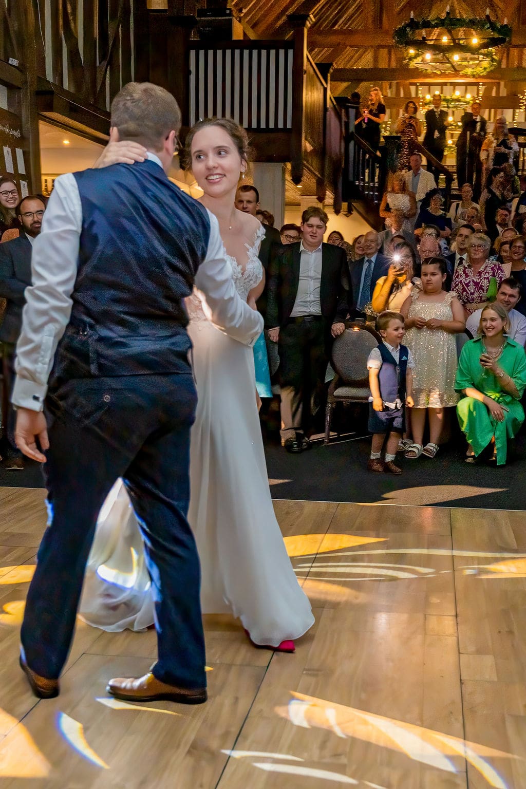 Bride and groom dancing at Essendon Country Club wedding venue as their guests watch on