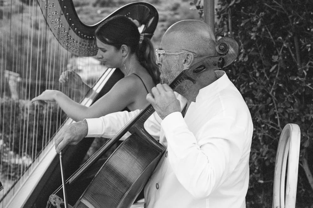 Black and White of a harpist and a cellist at the Majorca wedding